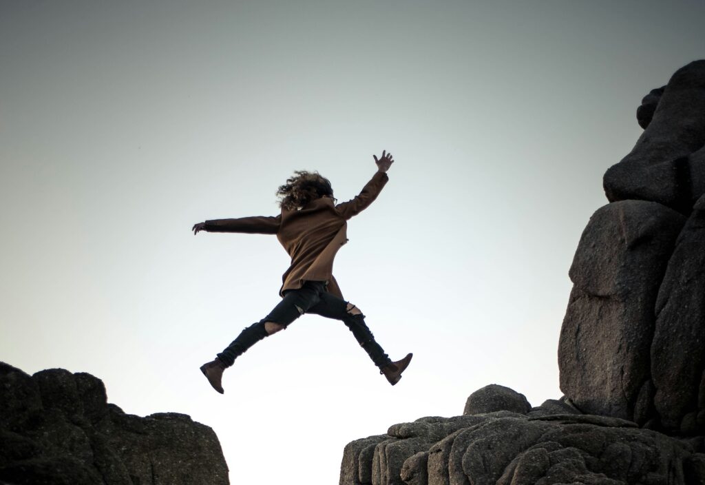 Person jumping from one ledge to another
