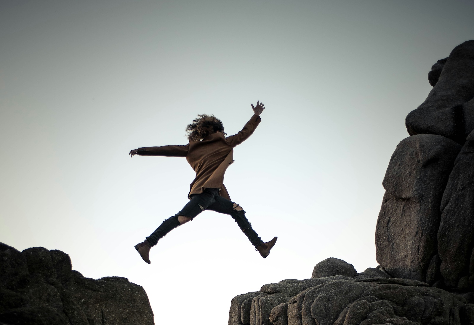Person jumping from one ledge to another